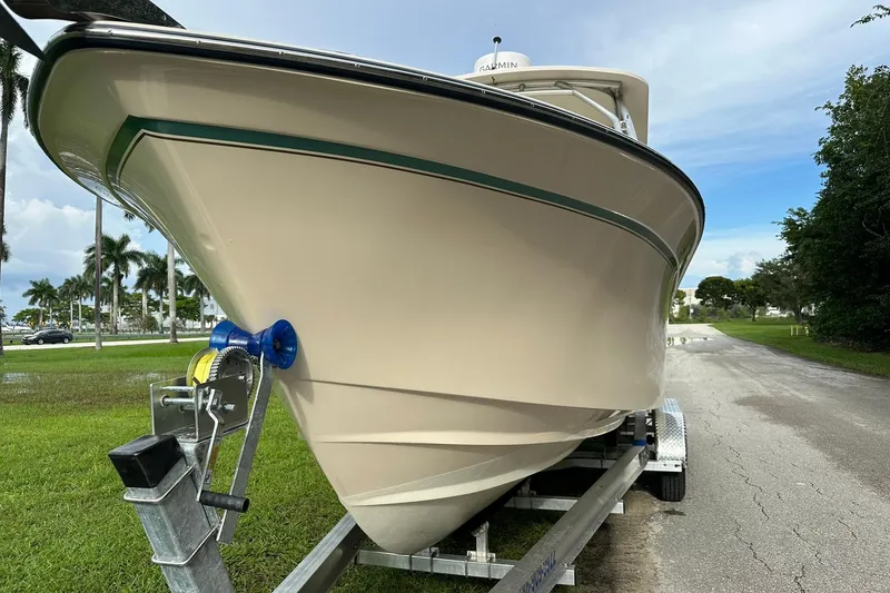 Slide: The Image of 2011 Grady-White Freedom 275 boat on trailer, parked on a grassy area. - 8