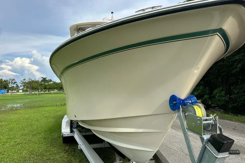 Slide: The Image of 2011 Grady-White Freedom 275 boat on trailer, grassy background, clear sky. - 9