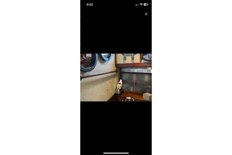 Slide: The Image of Interior of 1975 Dreadnought 32 Ketch with nautical decor and porthole windows. - 24