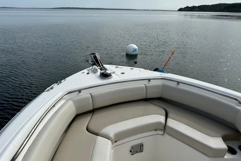 Slide: The Image of 2024 Boston Whaler 250 Outrage boat on calm water with buoy in view. - 12