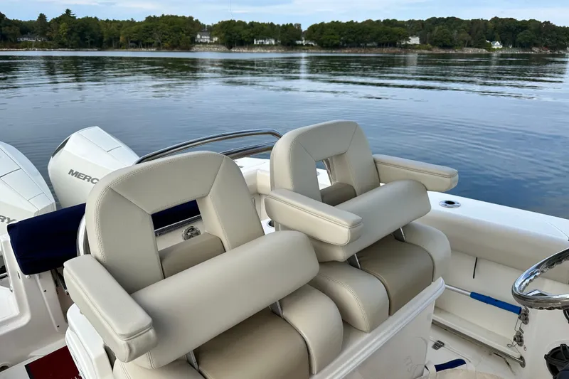 Slide: The Image of 2024 Boston Whaler 250 Outrage boat interior with marine toilet and control panel. - 19