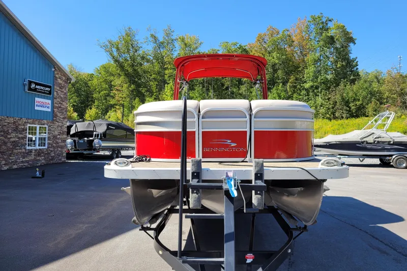 Slide: The Image of 2014 Bennington G23 pontoon boat on trailer at dealership, sunny day. - 14