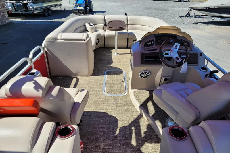 Slide: The Image of 2014 Bennington G23 pontoon boat interior with beige seating and steering console. - 4