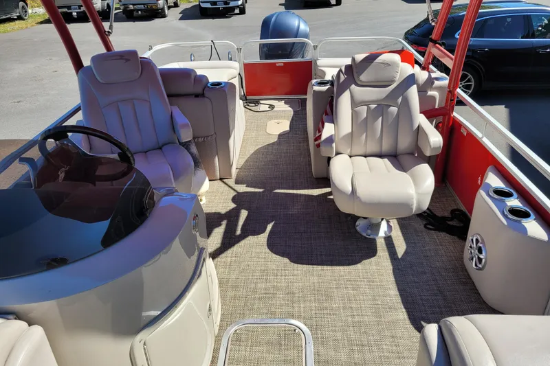 Slide: The Image of 2014 Bennington G23 pontoon boat interior with plush seating and modern dashboard. - 6