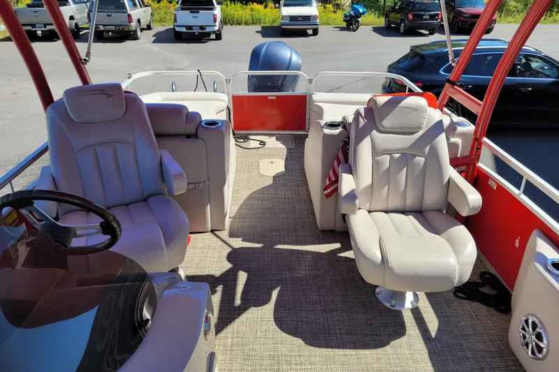 Slide: The Image of 2014 Bennington G23 boat interior with plush seating and steering wheel. - 7