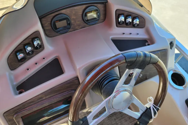 Slide: The Image of Dashboard of a 2014 Bennington G23 boat with steering wheel and controls. - 8