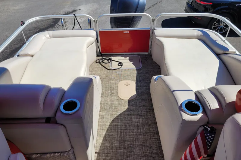 Slide: The Image of 2014 Bennington G23 pontoon boat interior with beige seating and cup holders. - 9