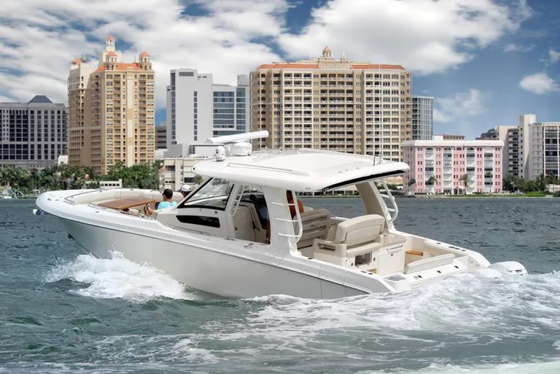 Slide: The Image of Manufacturer Provided Image: 2020 Boston Whaler 350 Realm cruising near city skyline. - 10