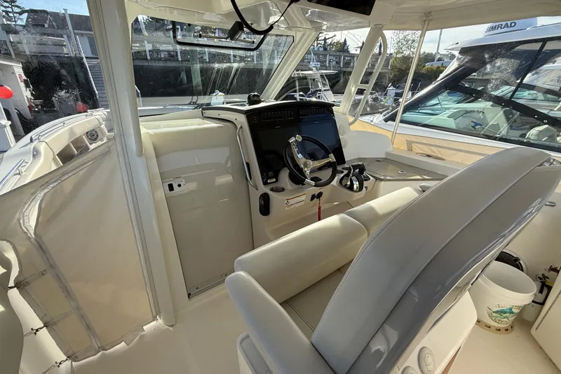 Slide: The Image of 2020 Boston Whaler 350 Realm cockpit with modern steering and navigation system. - 3
