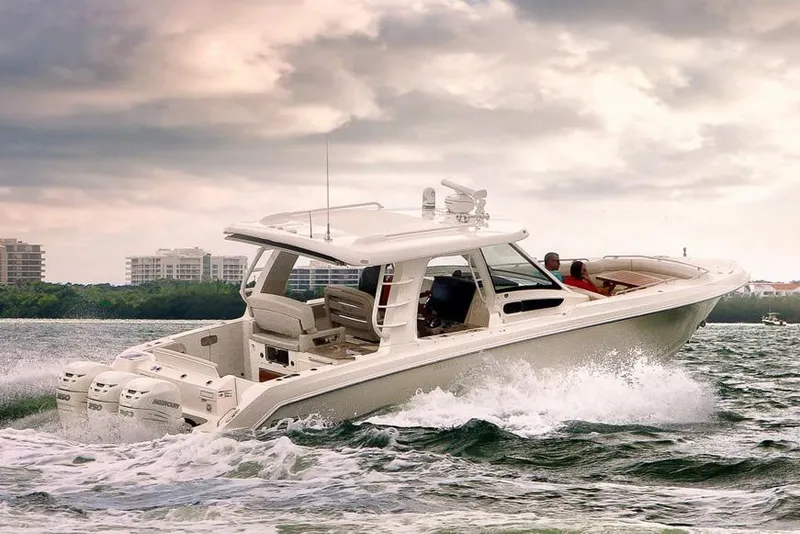 Slide: The Image of Manufacturer Provided Image: 2020 Boston Whaler 350 Realm cruising on water with cityscape background. - 9