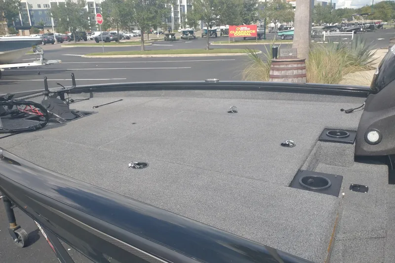 Slide: The Image of 2023 Tracker Pro Team 190 TX boat deck in a parking lot setting. - 7