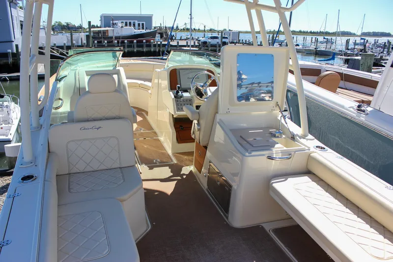 Slide: The Image of 2017 Chris-Craft Calypso 26 boat interior with luxurious seating and helm station. - 14