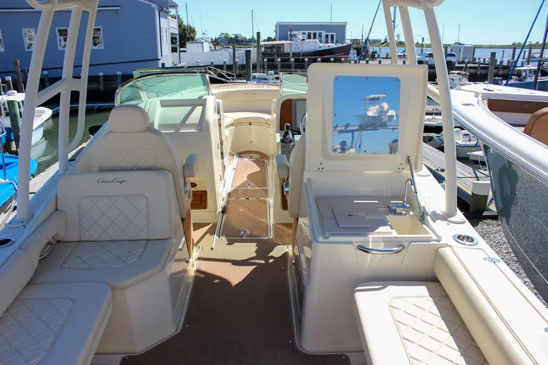 Slide: The Image of 2017 Chris-Craft Calypso 26 boat interior with luxurious seating and helm station. - 15