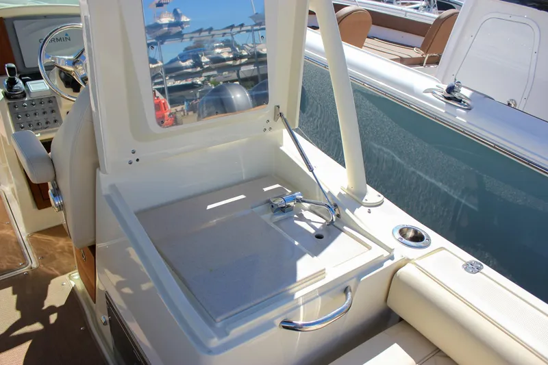 Slide: The Image of 2017 Chris-Craft Calypso 26 boat interior with helm and seating area. - 16