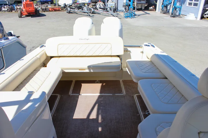 Slide: The Image of 2017 Chris-Craft Calypso 26 boat interior with beige seating and open deck layout. - 17
