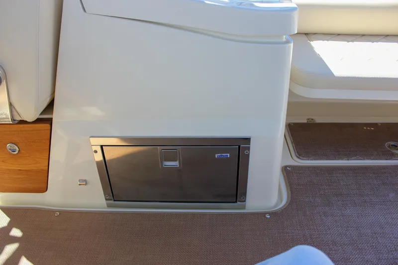 Slide: The Image of 2017 Chris-Craft Calypso 26 interior with built-in storage compartment and seating. - 20