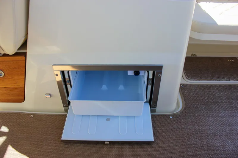 Slide: The Image of 2017 Chris-Craft Calypso 26 boat interior with open storage compartment. - 21