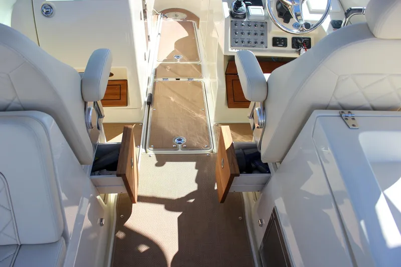 Slide: The Image of 2017 Chris-Craft Calypso 26 interior with dual seats and control panel. - 22