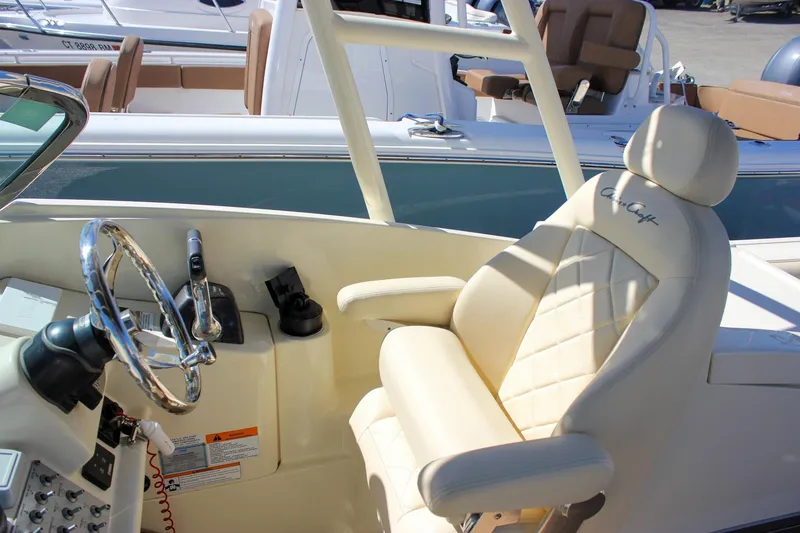 Slide: The Image of 2017 Chris-Craft Calypso 26 helm with luxurious seating and steering wheel. - 26