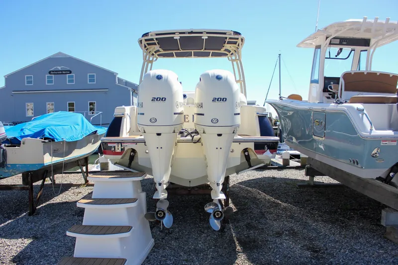 Slide: The Image of 2017 Chris-Craft Calypso 26 with twin Yamaha 200 engines at a marina. - 3