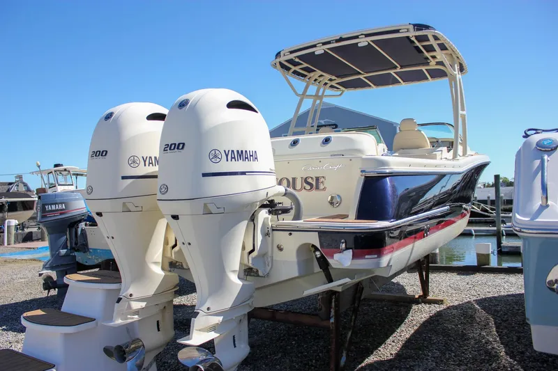Slide: The Image of 2017 Chris-Craft Calypso 26 boat with twin Yamaha 200 engines, docked outdoors. - 4