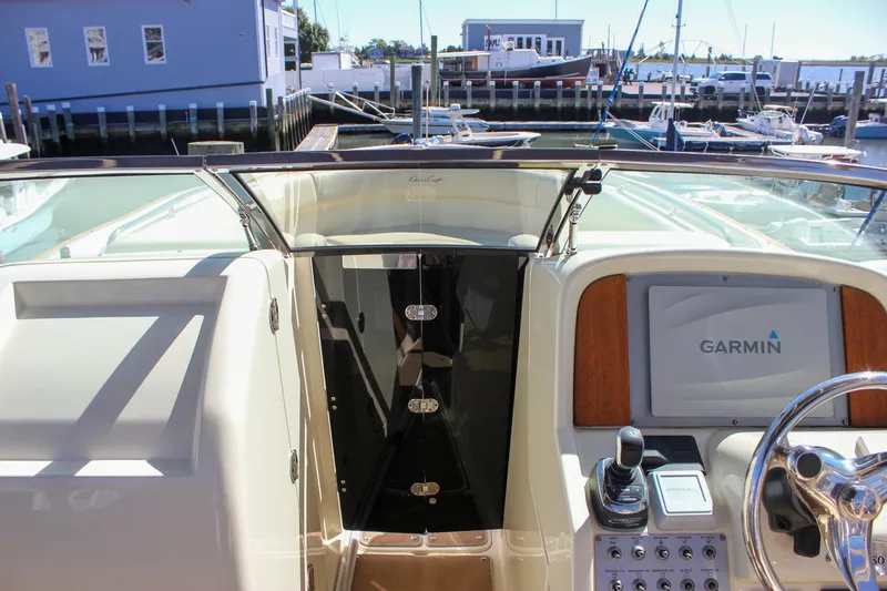 Slide: The Image of 2017 Chris-Craft Calypso 26 boat dashboard with Garmin navigation system at marina. - 42