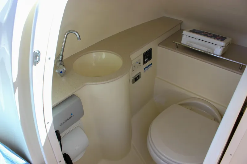 Slide: The Image of 2017 Chris-Craft Calypso 26 boat interior with sink and toilet. - 48