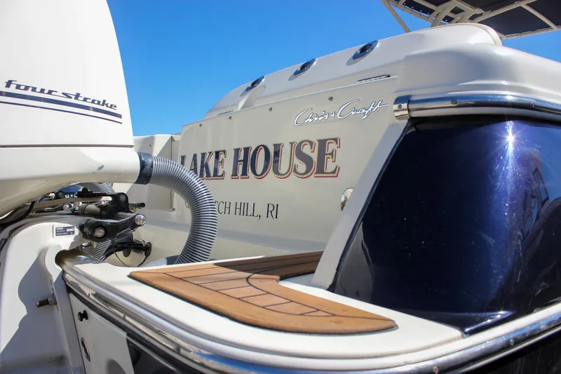 Slide: The Image of 2017 Chris-Craft Calypso 26 boat with "Lake House" name, four-stroke engine, sunny day. - 5