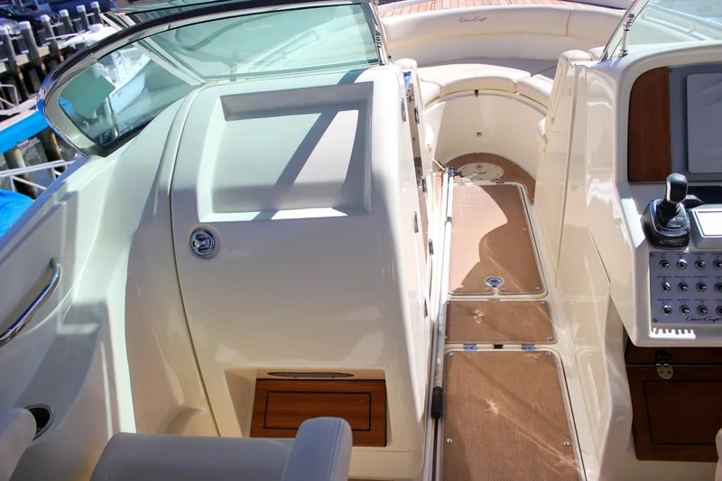 Slide: The Image of 2017 Chris-Craft Calypso 26 boat interior with helm controls and seating area. - 50