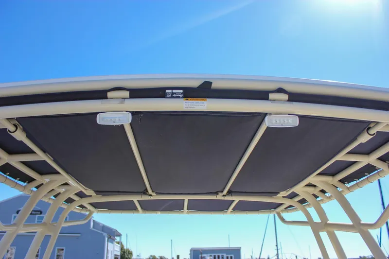 Slide: The Image of 2017 Chris-Craft Calypso 26 boat canopy under clear blue sky. - 51