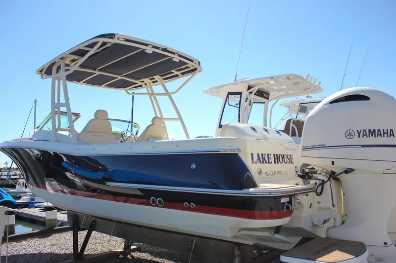 Slide: The Image of 2017 Chris-Craft Calypso 26 boat with Yamaha engine, docked under clear blue sky. - 53