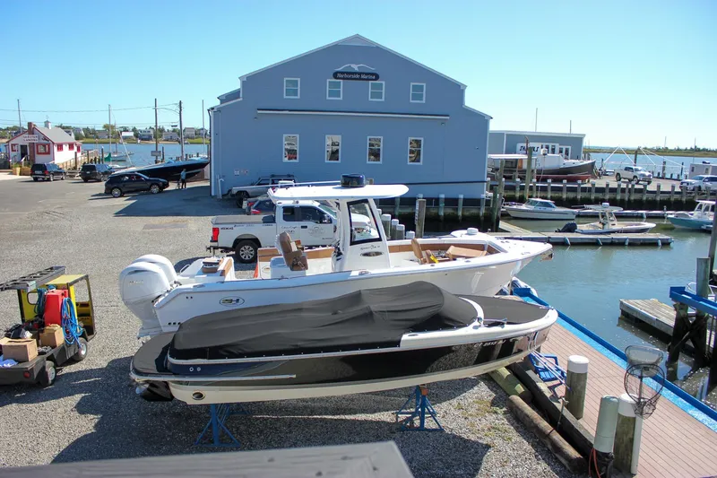 Slide: The Image of 2017 Chris-Craft Calypso 26 boat docked at a marina with waterfront view. - 54