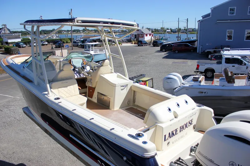 Slide: The Image of 2017 Chris-Craft Calypso 26 boat docked, featuring elegant seating and dual engines. - 59