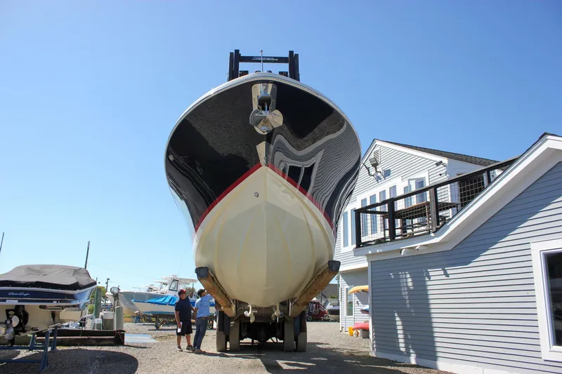 Slide: The Image of 2017 Chris-Craft Calypso 26 boat on trailer near building under clear blue sky. - 61