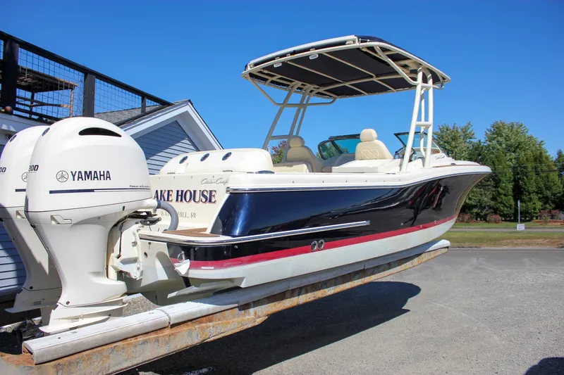 Slide: The Image of 2017 Chris-Craft Calypso 26 boat with Yamaha engines on a trailer. - 62