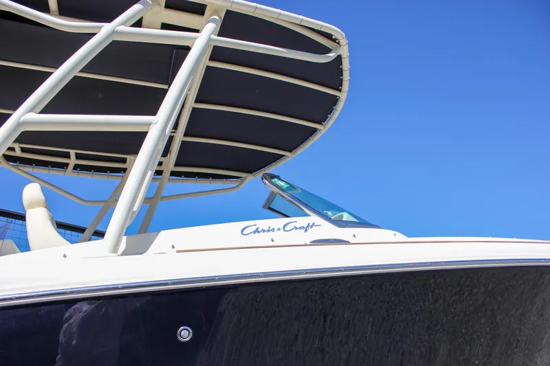 Slide: The Image of 2017 Chris-Craft Calypso 26 boat with canopy against clear blue sky. - 63