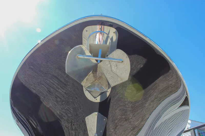 Slide: The Image of 2017 Chris-Craft Calypso 26 boat hull with anchor, viewed from below against blue sky. - 64