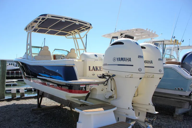 Slide: The Image of 2017 Chris-Craft Calypso 26 boat with twin Yamaha 200 engines docked at marina. - 66
