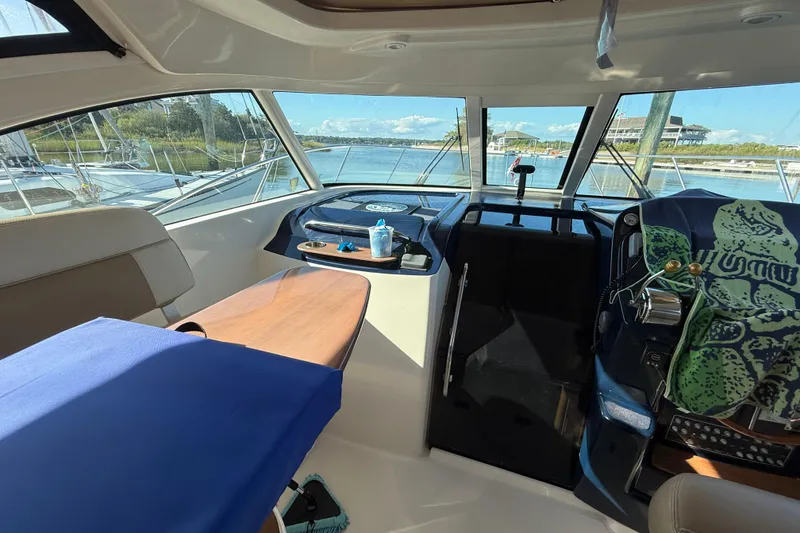 Slide: The Image of Interior of 2012 Tiara Yachts 3100 Coronet, featuring helm and seating area. - 19