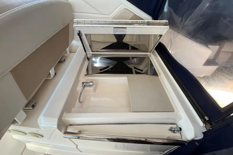 Slide: The Image of 2012 Tiara Yachts 3100 Coronet interior with built-in sink and storage compartment. - 20