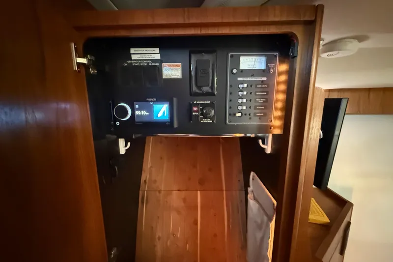 Slide: The Image of Control panel inside 2012 Tiara Yachts 3100 Coronet, featuring various switches and displays. - 21