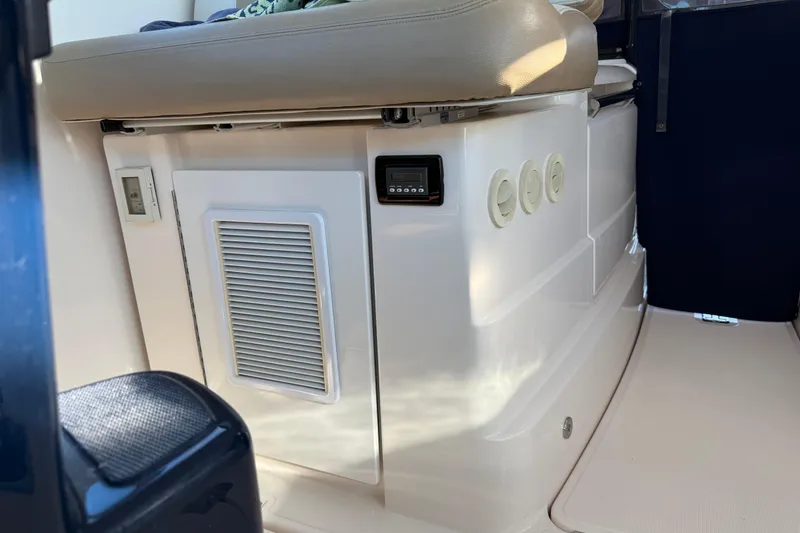 Slide: The Image of Interior view of 2012 Tiara Yachts 3100 Coronet, featuring seating and control panel. - 27