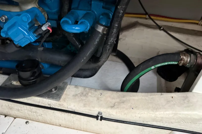 Slide: The Image of Engine compartment of a 2012 Tiara Yachts 3100 Coronet with visible hoses and components. - 30