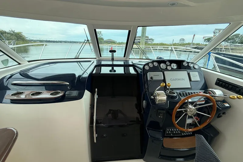Slide: The Image of Cockpit of 2012 Tiara Yachts 3100 Coronet with Garmin navigation system and wooden steering wheel. - 36