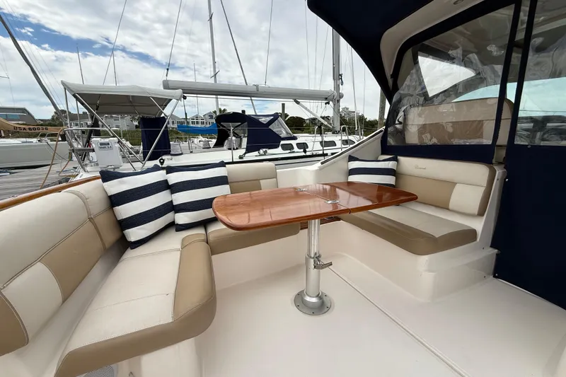 Slide: The Image of 2012 Tiara Yachts 3100 Coronet interior with seating, table, and striped cushions. - 39