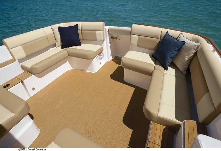 Slide: The Image of Manufacturer Provided Image: Spacious seating area on 2012 Tiara Yachts 3100 Coronet, with beige cushions and blue pillows. - 6