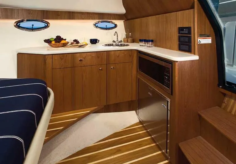 Slide: The Image of Manufacturer Provided Image: 2012 Tiara Yachts 3100 Coronet interior kitchen with wood cabinetry and modern appliances. - 8