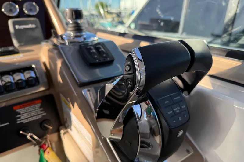 Slide: The Image of 2016 Formula 37 Performance Cruiser helm controls with throttle and navigation instruments. - 18