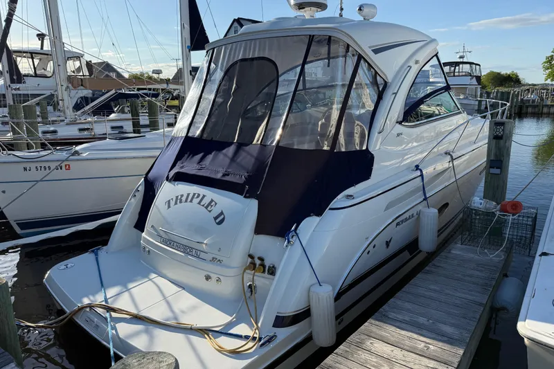 The Image of 2016 Formula 37 Performance Cruiser docked at marina, featuring sleek design and navy canopy. - 2