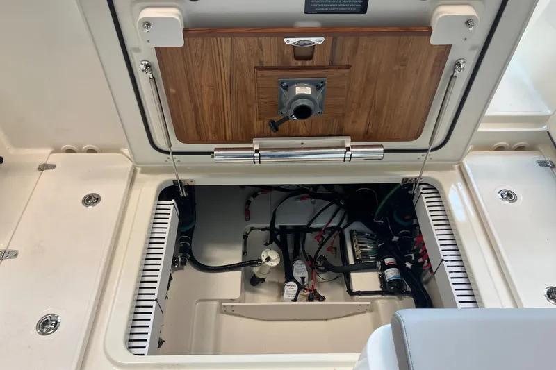 Slide: The Image of Open hatch of 2026 Boston Whaler 330 Vantage showing internal components and wiring. - 13